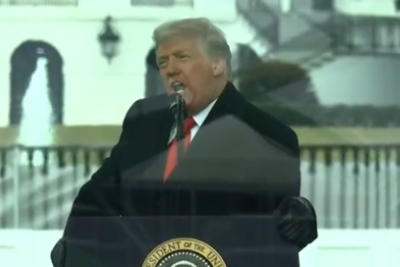 Trump leaning on podium in freezing wind Jan 6